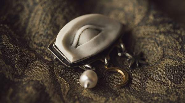 Editorial illustration for From Cloak Pin to Statement Piece: How the Brooch Evolved Across Three Millennia